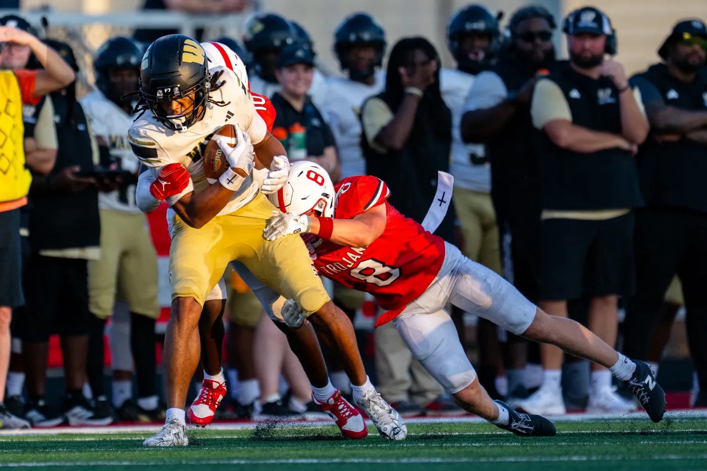 Zechariah Wallace carrying the football while being tackled during Warren Central's game at Center Grove
